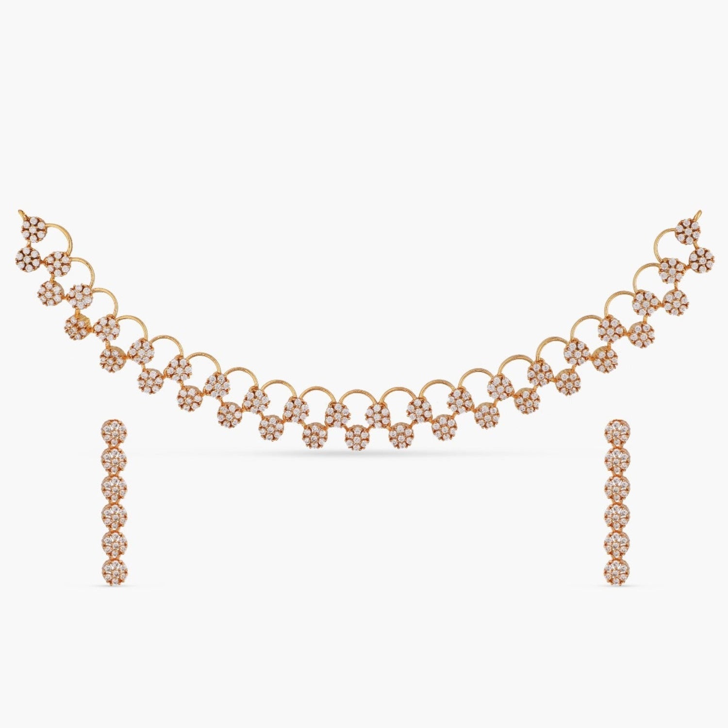 A picture of Indian artificial jewelry. It is a white gold plated necklace and earrings set with intricate floral designs, featuring Cubic Zirconia.